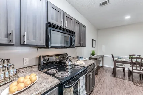 Espresso Walnut kitchen, apartment community refaced with a Qwikkit cabinet refacing kit