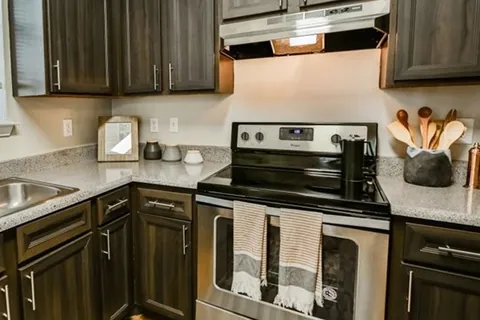 Dark woodgrain-look kitchen refaced with a Qwikkit cabinet refacing kit
